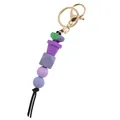 Macro view of purple potted plant silicone beads keychain with gold lobster clasp - Purple