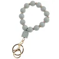 Détail d'un bracelet en perles de silicone gris avec pendentif arc-en-ciel et fermoir doré - Bracelet Porte-clés Charme Arche Gris