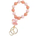 Detail of pink silicone beaded keychain bracelet with golden spacer rings and flamingo charm - Pink Orange Flamingo Charm Keychain Bracelet