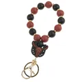 Detail of beaded wristlet keychain with silicone bull skull pendant and golden hardware - Black Bead Bull Charm Keychain Bracelet
