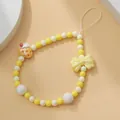 Bijou de téléphone en perles avec noeud jaune et breloque gâteau à la fraise - Lanière de Téléphone Nœud Gâteau à la Fraise