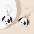 Detail of dog pendant earrings featuring white enamel and pink tongue with golden hooks - Black