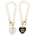 Close-up of black and white heart enamel alphabet D pendants with golden chain links - Black and White-Letter D
