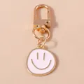 Cartoon smiley face keychain pendant with gold plating and white enamel charm - Light Pink