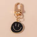 Cartoon smiley face keychain in black and gold alloy finish for trendy accessory - Black
