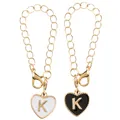 Golden heart-shaped enamel keychain charms with letter K in black and white colors - Black and White-Letter K