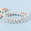 Gros plan de bracelets double couche avec des perles boules serties de cristaux brillants - Collier Boule Strass Blanc 40CM