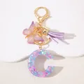 Macro view of purple resin letter C keychain with heart glitter and butterfly tassel - Letter C Purple Tassel