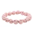 Close-up of pink gothic skull bead bracelet with natural stone texture on white background - Pink