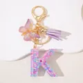 Pink sequin resin letter K keychain with purple butterfly and tassel in gold finish - Letter K Purple Tassel
