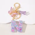 Detail of resin letter N keychain with pink sequins, purple butterfly, and silk tassel charm - Letter N Purple Tassel
