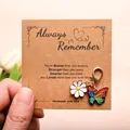 Daisy and butterfly charms on a kraft paper card with motivational text held by hand - Colorful