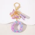 Detail of pink sequin resin letter O keychain with butterfly charm and purple tassel - Letter O Purple Tassel