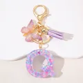Detail of resin letter Q keychain with pink sequins, purple butterfly and suede tassel - Letter Q Purple Tassel