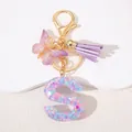 Detail of pink resin letter S keychain with gold butterfly charm and purple suede tassel - Letter S Purple Tassel