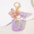 Detail of purple glitter letter U keychain with butterfly charm and purple tassel - Letter U Purple Tassel