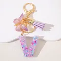 Detail of resin letter V keychain with purple sequins, gold clasp, butterfly and tassel - Letter V Purple Tassel
