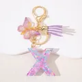 Detail of pink heart sequin resin letter X keychain with butterfly charm and purple tassel - Letter X Purple Tassel