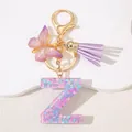 Close-up of resin letter Z keychain with pink sequins and purple butterfly tassel - Letter Z Purple Tassel