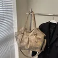 Vintage taupe faux leather tote bag with distressed texture and metal buckle accents - Khaki