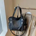 Large black minimalist tote bag with silver studs and adjustable shoulder strap - Black