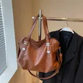 Brown large capacity leather tote bag with silver rivets and adjustable shoulder strap - Yellow Brown