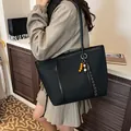 Classic black tote bag with long handles and a colorful wooden bead charm for women - Black
