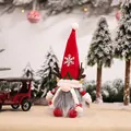 Christmas gnome doll with red reindeer antlers and snowflake hat in a snowy forest scene - Female Doll Ornament (E-DD23)