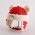 Close-up of red winter earflap hat with plush cream lining and bear patch detail - Toddlers 1-3 Years / Red