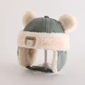 Detailed close-up of plush bear ear winter hat with warm faux fur lining and chin strap - Toddlers 1-3 Years / Pale Green