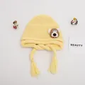 Detailed texture of yellow knitted baby hat featuring brown bear patch and tassels - Baby One Size Elastic / Little Bear Yellow