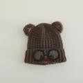 Detailed close-up of brown knit hat with cute bear ears and round glasses decoration - Dark Coffee
