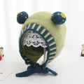 Detailed knit texture of green baby winter hat with pom-poms and blue ribbed earflaps - Kids (2-6 Years) / Grass Green