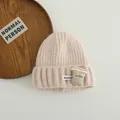Detail of light pink knitted beanie featuring a cartoon coffee cup patch and soft texture - 3-10 Years (Stretchy) / Beige