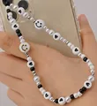 Handmade black and white beaded phone strap featuring heart and smiley face charms - Heart And Smile Style / Black and White