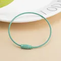 Macro view of mint green stainless steel wire keychain with secure screw lock mechanism - Mint Green