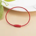 Macro shot of red coated steel wire keychain with secure screw clasp and non-slip texture - Red