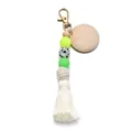 Macro view of silicone beads with tassel and DIY wood tag on a golden keychain - Yellow Green Tassel Style