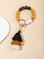Detailed view of bohemian silicone bead keychain with tricolor fringe tassel and golden ring - Quiet Garden Black-Brown (PZ2307159640)