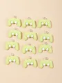 Flat lay macro of twelve light green mini resin game controller charms with metal rings - Dark Green And White Game Controller