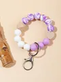 Detalle de llavero con cuentas de silicona mármol púrpura y corazón de madera natural - Púrpura Lavanda