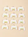 Flat lay macro of twelve white resin gamepad pendants for creative DIY jewelry making - White And Green Game Controller
