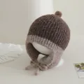 Close-up of baby knit hat showing ribbed texture and soft ear flaps with ties - Baby 2-5 Years Old / Coffee
