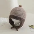 Detail of baby knit hat showing pom-pom and plush texture in two-tone brown and beige - Baby 2-5 Years Old / Light Gray