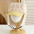 Detail of winter trapper hat with plaid pattern and warm faux fleece lining on a model stand - Kids / Yellow