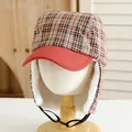 Detailed view of kids' winter trapper hat with red plaid pattern and warm faux fur lining - Kids / Burgundy