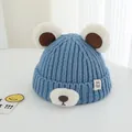 Detailed knit texture of blue winter baby hat with cute bear ears and plush accents - 2-7 Years / Blue