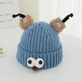Close-up of blue monster knit hat featuring 3D eyes, fuzzy ears, and spiral tentacles - Blue