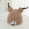 Detail shot of brown knit hat showing large googly eyes and plush antenna texture - Khaki