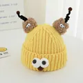 Detail of yellow knit monster hat with large eyes and brown plush antennae for kids - Yellow